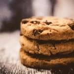 The chewiest chocolate chip cookie texture is ensured by melted butter, a higher proportion of brown sugar than white sugar, cornstarch, and an additional egg yolk.