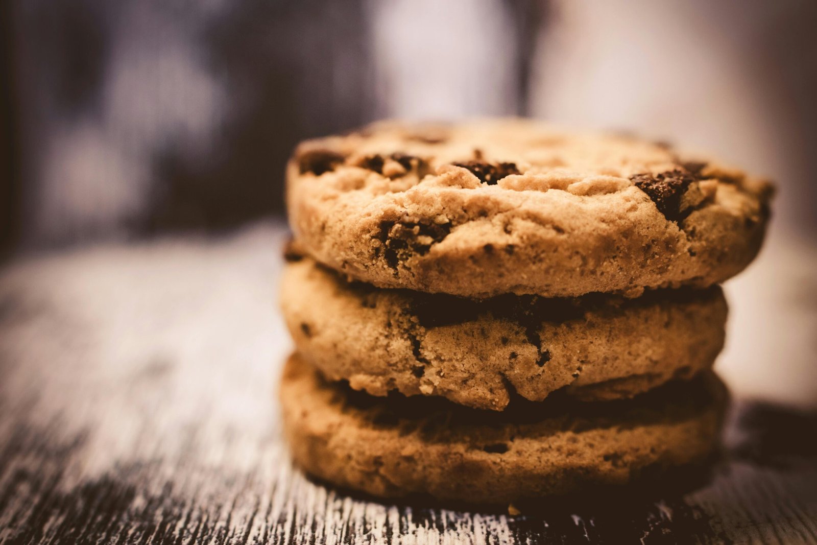 The chewiest chocolate chip cookie texture is ensured by melted butter, a higher proportion of brown sugar than white sugar, cornstarch, and an additional egg yolk.